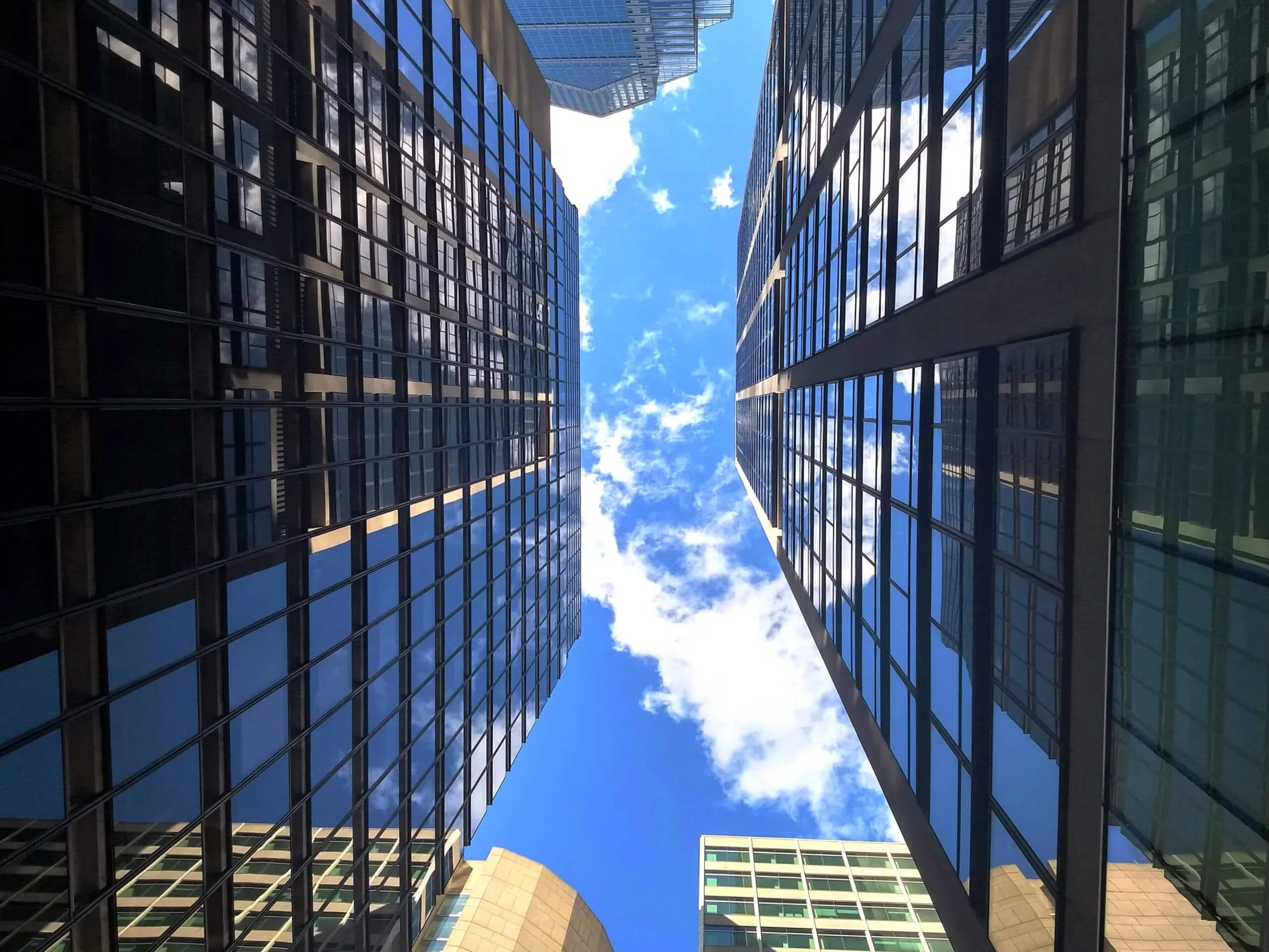 Picture looking up to the sky between two buildings in Center City Philadelphia - banner image for Permit Philly, a company of permit expediters, zoning consultants, and construction paperwork experts.